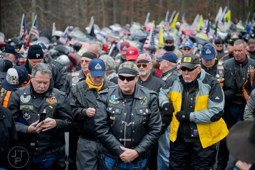 Chet Mingledorff (center) and other members of the Patriot Guard Riders  wait to pay tribute to United States Army Sergeant First Class Omar Forde at NorthStar Church in Kennesaw on Saturday, December 28, 2013. 