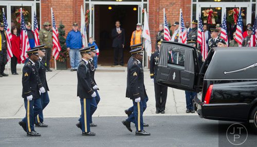 Members of the honor guard for United States Army Sergeant First Class Omar Forde march towards the hearse to retrieve his casket at NorthStar Church in Kennesaw on Saturday, December 28, 2013. 