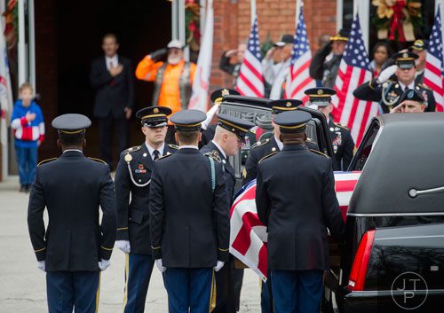 Members of the honor guard for United States Army Sergeant First Class Omar Forde remove his casket from the hearse at NorthStar Church in Kennesaw on Saturday, December 28, 2013. 