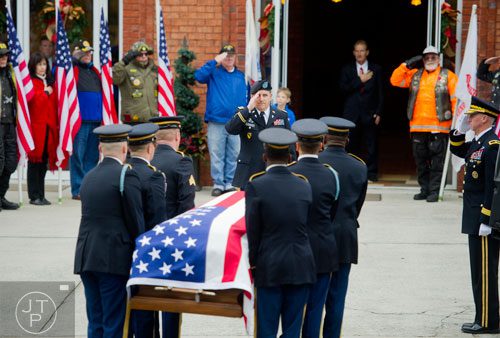 Members of the honor guard for United States Army Sergeant First Class Omar Forde salute as his casket is carried into NorthStar Church in Kennesaw on Saturday, December 28, 2013. 