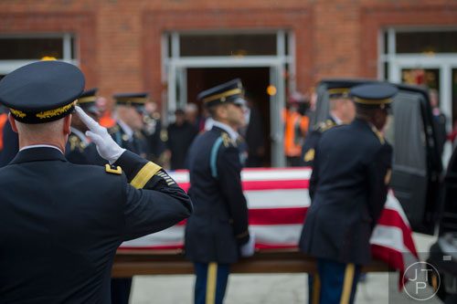 Brig. Gen. Peter Jones (left) slautes as members of the honor guard for United States Army SFC Omar Forde load his casket into a hearse at NorthStar Church in Kennesaw on Saturday, December 28, 2013. 