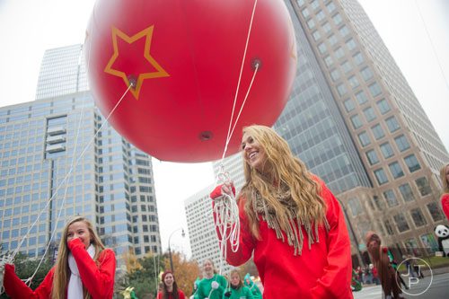 Savannah Strickland (center) helps guide an ornament ballon during the 33rd annual Children's Christmas Parade in Atlanta on Saturday, December 7, 2013.