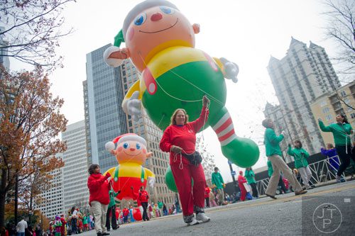 Nina Sadler (center) helps guide an elf ballon during the 33rd annual Children's Christmas Parade in Atlanta on Saturday, December 7, 2013. 