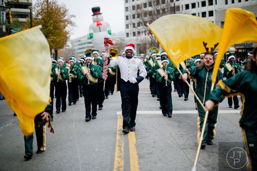Grayson High School drum major Winston Johnson (center) leads his band down Peachtree Street during the 33rd annual Children's Christmas Parade in Atlanta on Saturday, December 7, 2013. 