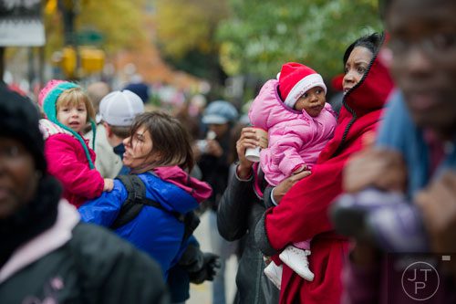 Bea White (right) holds her daughter Siara as they watch the 33rd annual Children's Christmas Parade in Atlanta on Saturday, December 7, 2013. 