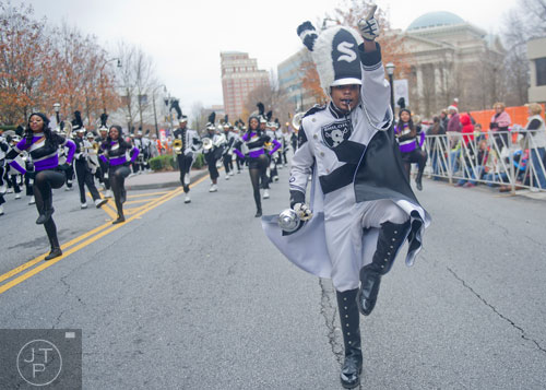 Shiloh High School drum major Joshua Anderson (right) leads his band down Peachtree Street during the 33rd annual Children's Christmas Parade in Atlanta on Saturday, December 7, 2013. 