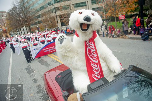 The Coca-Cola Polar Bear waves to the crowd during the 33rd annual Children's Christmas Parade in Atlanta on Saturday, December 7, 2013. 