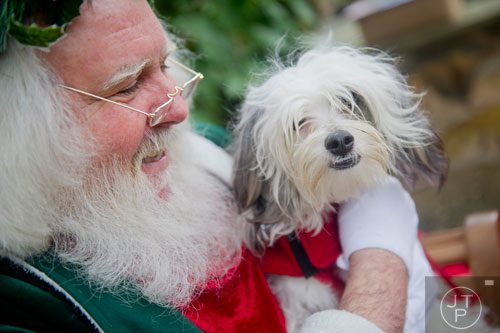 Santa Claus holds Zubi, a powder puff Chinese crested, during the Reindog Parade at the Atlanta Botanical Garden in Midtown on Saturday, December 7, 2013.