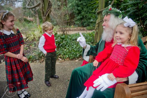 Sophie Lyman (left), her brother McCoy and sister Lizzie visit with Santa at the Atlanta Botanical Garden on Saturday, December 7, 2013.