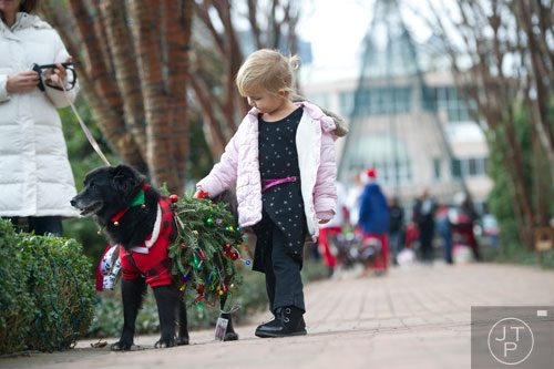 Olivia Sarros pets her dog Beaumont as they walk around the Atlanta Botanical Garden on Saturday, December 7, 2013.