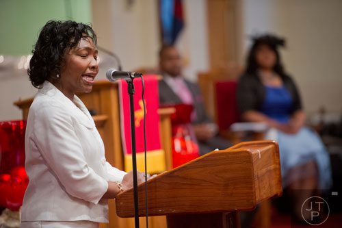 Mary Norris makes announcements to the congregation during the worship services at Mt. Welcome Missionary Baptist Church in Decatur on Sunday, December 8, 2013.