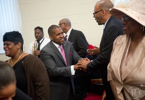 Pastor Darryl Roberts (center) greets Winford Hartry during the worship services at Mt. Welcome Missionary Baptist Church in Decatur on Sunday, December 8, 2013.