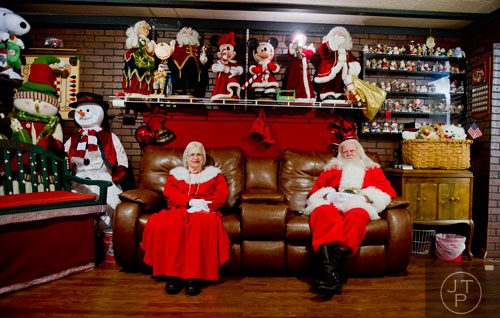 Santa Claus and Mrs. Claus take a moment before guests arrive at Ronald and Betty Page's home in Canton on Thursday, December 12, 2013.