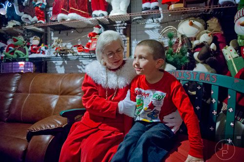 Daniel Garland sits next to Mrs. Claus at Ronald and Betty Page's home in Canton on Thursday, December 12, 2013.