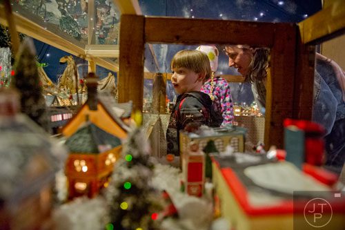 Luke Sanders and his mother Karen look at the train display at Ronald and Betty Page's home in Canton on Thursday, December 12, 2013.