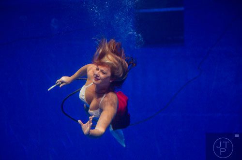 Crystal Videgar swims as part of the Weeki Wachi Mermaids at the Georgia Aquarium on Friday, December 13, 2013.