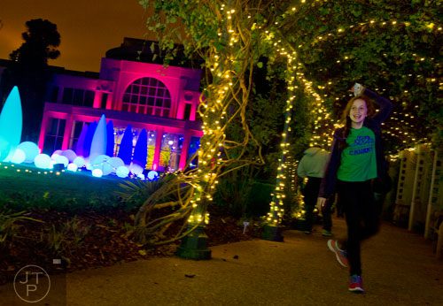 Marianna Richmond twirls around as she dances to the music played during Garden Lights Holiday Nights at the Atlanta Botanical Garden in the Midtown neighborhood of Atlanta on Thursday, November 21, 2013. 