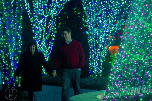 Ann Guinn (left) holds hands with her husband Matt during Garden Lights Holiday Nights at the Atlanta Botanical Garden in the Midtown neighborhood of Atlanta on Thursday, November 21, 2013. 
