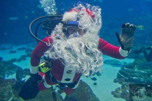 Scuba Claus waves to the crowd at the Georgia Aquarium during an appearance on Friday, December 13, 2013. 