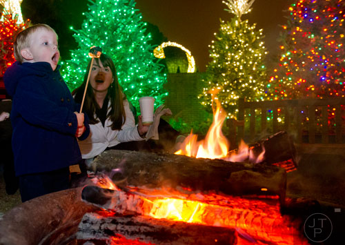 Gardner Quiner (left) and Holly Covett blow out a marshmallow by the fire during Garden Lights Holiday Nights at the Atlanta Botanical Garden in the Midtown neighborhood of Atlanta on Thursday, November 21, 2013. 