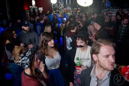 Emma Nare (right) waits to compete in Battle of the Beards as she talks to Brittany Sloss at Smith's Olde Bar in Atlanta on Saturday, December 14, 2013. 