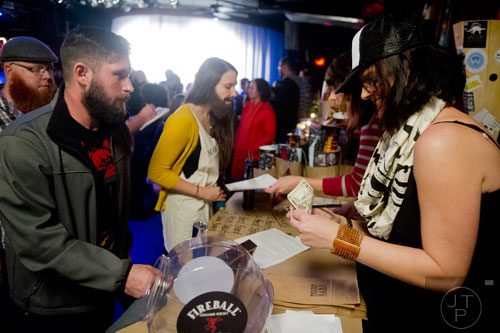 Lewis Smith (left) registers for Battle of the Beards with Jen Fowler at Smith's Olde Bar in Atlanta on Saturday, December 14, 2013. 