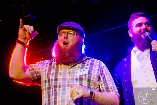 Seth Nixon (left) plays up to the crowd as he talks with emcee Mike Albenese while competing during Battle of the Beards at Smith's Olde Bar in Atlanta on Saturday, December 14, 2013.