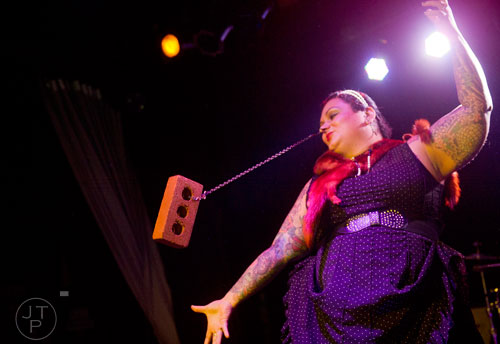 Maybelle Steele swings a brick from her nostrils as she performs on stage at Smith's Olde Bar in Atlanta during Battle of the Beards on Saturday, December 14, 2013.