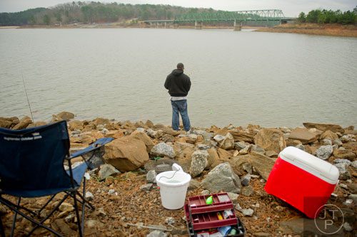 Joe Fountain braves the rainy weather as he fishes at Lake Allatoona in Cartersville on Saturday, December 28, 2013.   