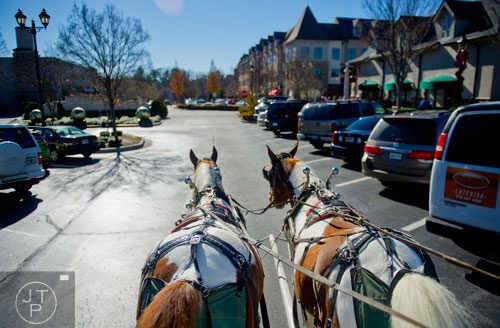 Jesse James and his brother Frank pull a carriage around The Forum in Peachtree Corners on Friday, November 29, 2013.