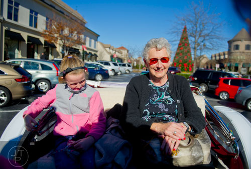 Claire Kloeber and her grandmother Libby ride a horse drawn carriage around the The Forum in Peachtree Corners on Friday, November 29, 2013.