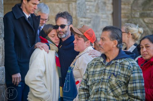 Steven Satterfield (center) hugs Jodi Fleck (left) and Katherine Perry before the start of the funeral service for Ria Pell at Westview Cemetery in Atlanta on Saturday, November 30, 2013. 