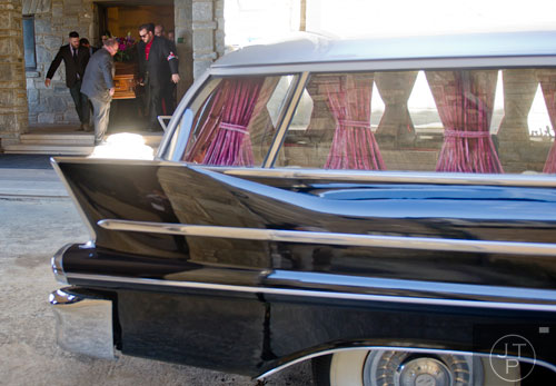 Ben Cheeves (left) and Jason Deck carry the casket of Ria Pell towards a hearse at Westview Cemetery in Atlanta on Saturday, November 30, 2013. 