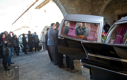 Alex Skalicky (right) and the other pall bearers load the casket of Ria Pell into a hearse at Westview Cemetery in Atlanta on Saturday, November 30, 2013. 