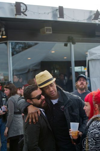 Luis Ponce (left) hugs Adam Darby outside of Ria's Bluebird in Atlanta after the funeral for Ria Pell on Saturday, November 30, 2013. 