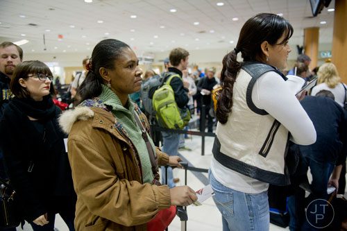 Margaret Hyatt (center) waits in the security line at Hartsfield-Jackson International Airport in Atlanta on Sunday, December 1, 2013.   
