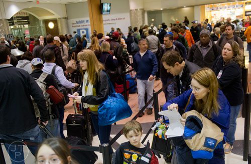 Jacquie Carmen (right) waits in the security line at Hartsfield-Jackson International Airport in Atlanta on Sunday, December 1, 2013.  