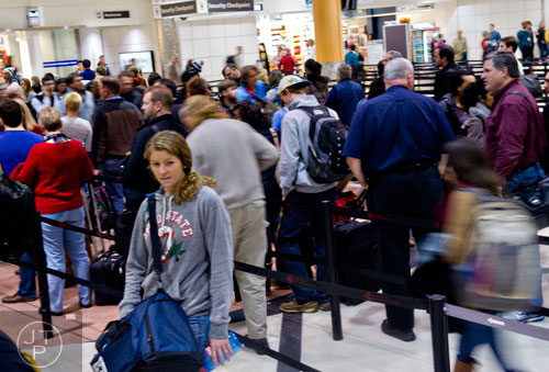 Jennifer Johnston (left) waits in the security line at Hartsfield-Jackson International Airport in Atlanta on Sunday, December 1, 2013.