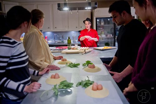 Chef Sandy Houdeshell (center) talks to her students during the Pastabilities class at The Cooking School at Irwin Street in Atlanta on Saturday, January 18, 2014.   