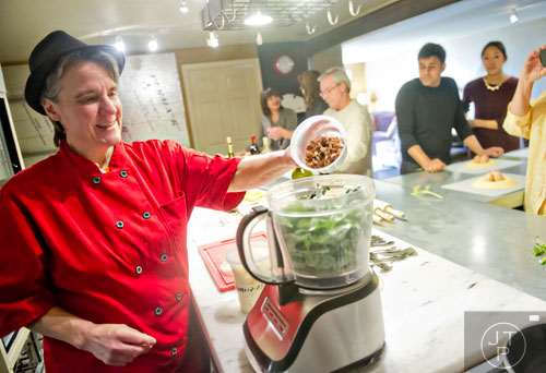 Chef Sandy Houdeshell (left) prepares a pesto sauce during the Pastabilities class at The Cooking School at Irwin Street in Atlanta on Saturday, January 18, 2014.  