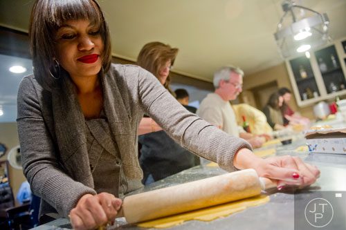 Krista Nelson uses a rolling pin to press her dough during the Pastabilities class at The Cooking School at Irwin Street in Atlanta on Saturday, January 18, 2014. 