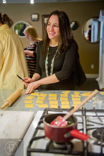 Danielle Zamarelli cuts her dough into squares as she prepares her handmade ravioli during the Pastabilities class at The Cooking School at Irwin Street in Atlanta on Saturday, January 18, 2014.  