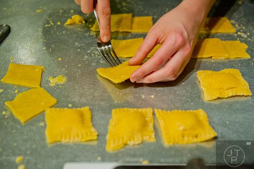 Danielle Zamarelli uses a fork to press her handmade ravioli together during the Pastabilities class at The Cooking School at Irwin Street in Atlanta on Saturday, January 18, 2014. 
