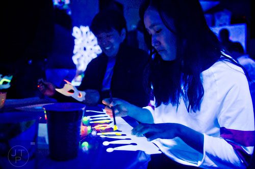 Michelle Hong (right) and Winston Kim during "Black Light Art" Adult Saturday Night at Zone of Light Studio in Atlanta on Saturday, January 18, 2014. 