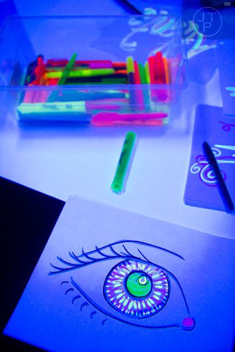Artwork sits on a table during "Black Light Art" Adult Saturday Night at Zone of Light Studio in Atlanta on Saturday, January 18, 2014. 