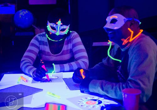 Michelle Williams (left) and John Hatchet use highlighters to draw during "Black Light Art" Adult Saturday Night at Zone of Light Studio in Atlanta on Saturday, January 18, 2014.