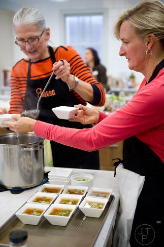 Patricia Cummings (right) and Theresa Mitchell help Chef MJ Conboy plate miso soup during the Exploring a Plant-Based Diet class at the Cook's Warehouse in Marietta on Tuesday, January 21, 2014. 