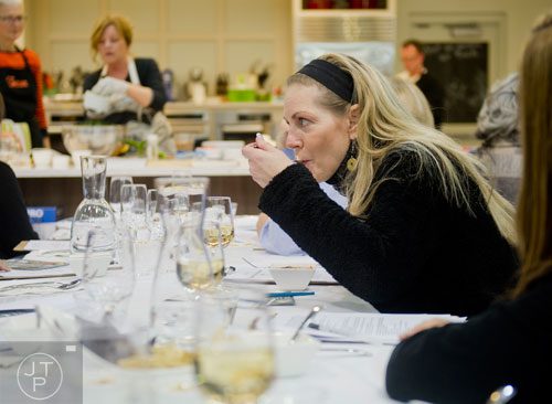 Cynthia Schoch (right) tries a bite of miso soup as Chef MJ Conboy demonstrates different recipes during the Exploring a Plant-Based Diet class at the Cook's Warehouse in Marietta on Tuesday, January 21, 2014.  