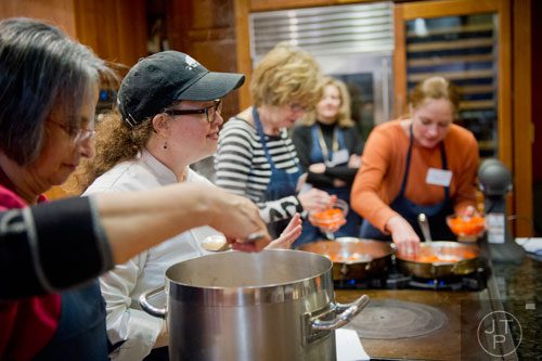 Chef Samantha Enzmann (left) talks to her students during a cooking class at the Salud Cooking School at Harry's Farmers Market in Roswell on Thursday, January 23, 2014. 