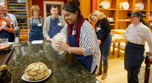 Supriya Shridharan (center) flips a zuccotto during a cooking class at the Salud Cooking School at Harry's Farmers Market in Roswell on Thursday, January 23, 2014. 